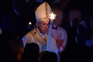 epa05232059 Pope Francis holds a candle during the Easter Vigil mass at the Saint Peter's Basilica in Vatican City, Vatican, 26 March 2016. Christians around the world are marking the Holy Week, commemorating the crucifixion of Jesus Christ, leading up to his resurrection on Easter.  EPA/ETTORE FERRARI