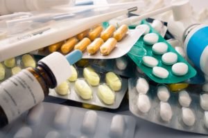 13584767 - close up of packs of pills, tablets, capsules, nose drops and thermometer.